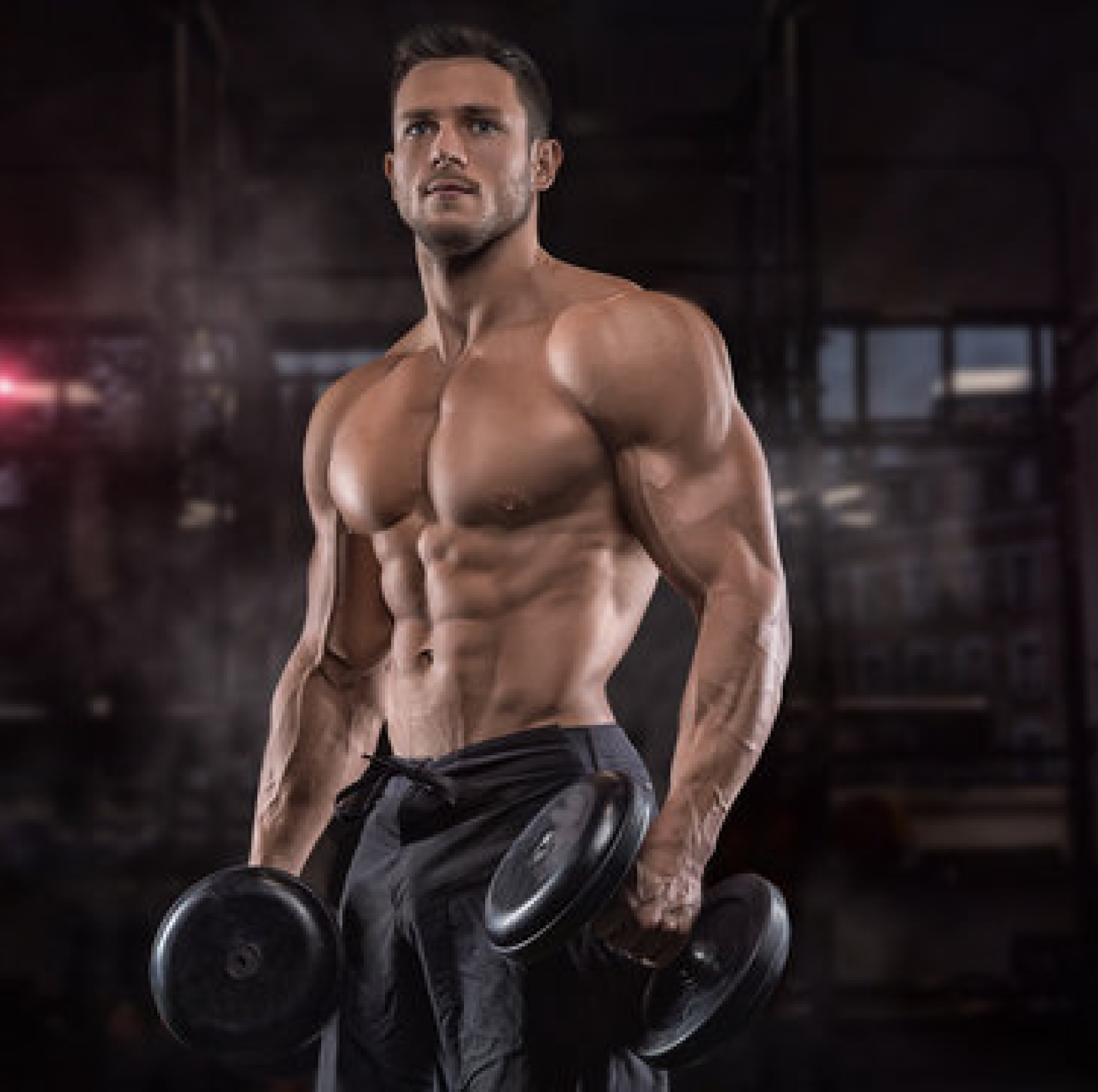 A strength coach holding dumbbells